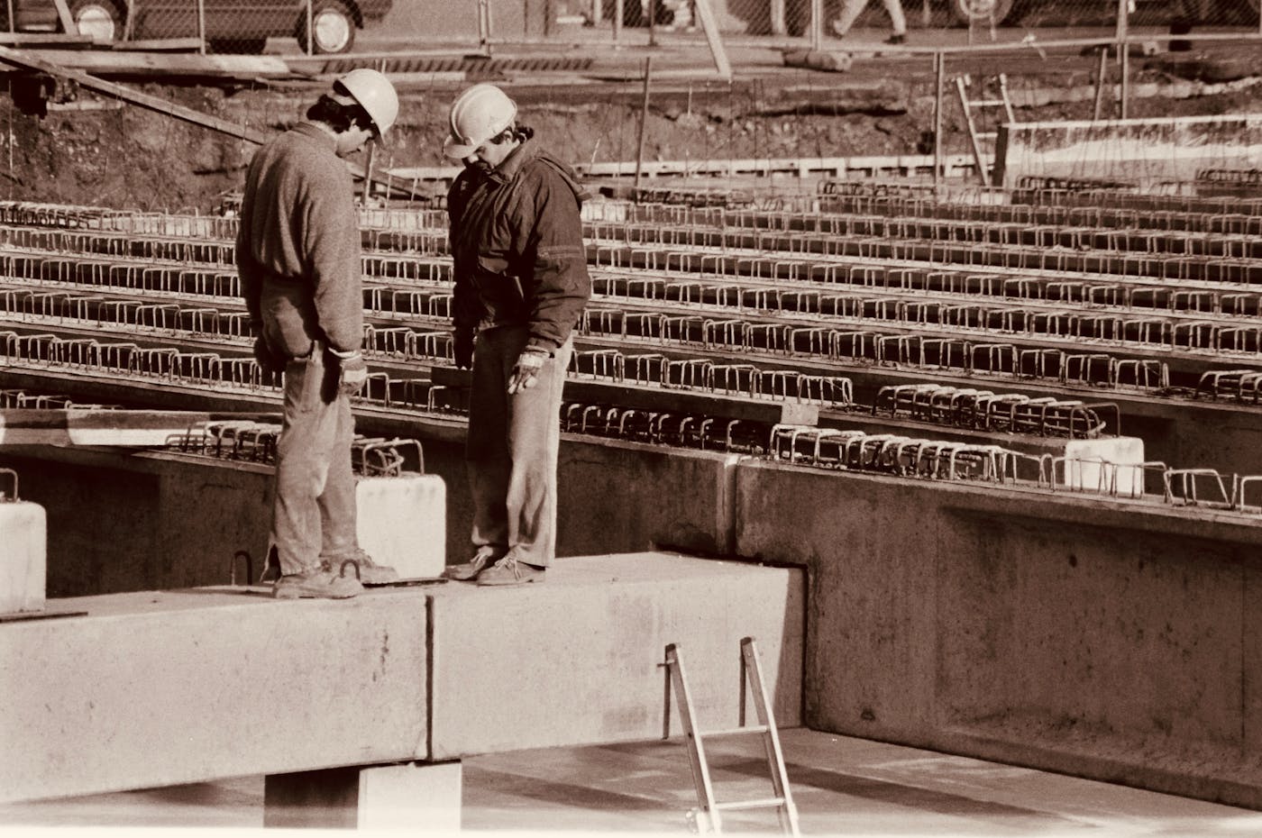 Construction workers reviewing project plans on a job site